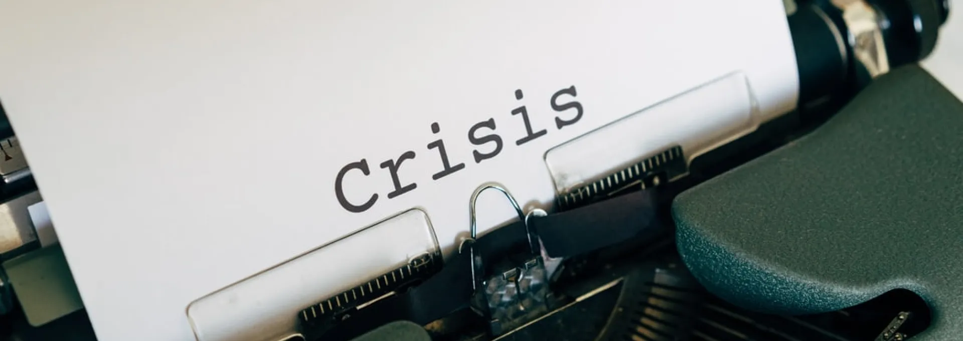 Type Writer with the words Crisis typed out