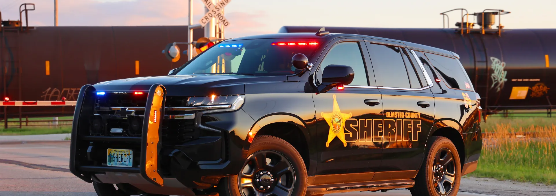 Squad in road blocking traffic as train crosses