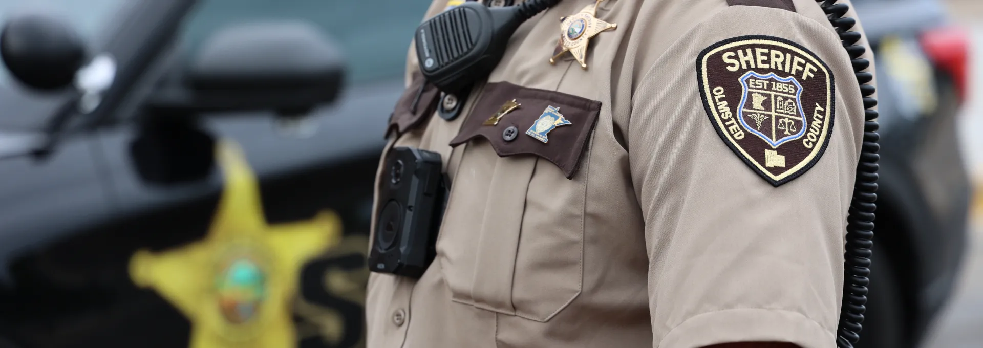 Deputy standing new squad in uniform.