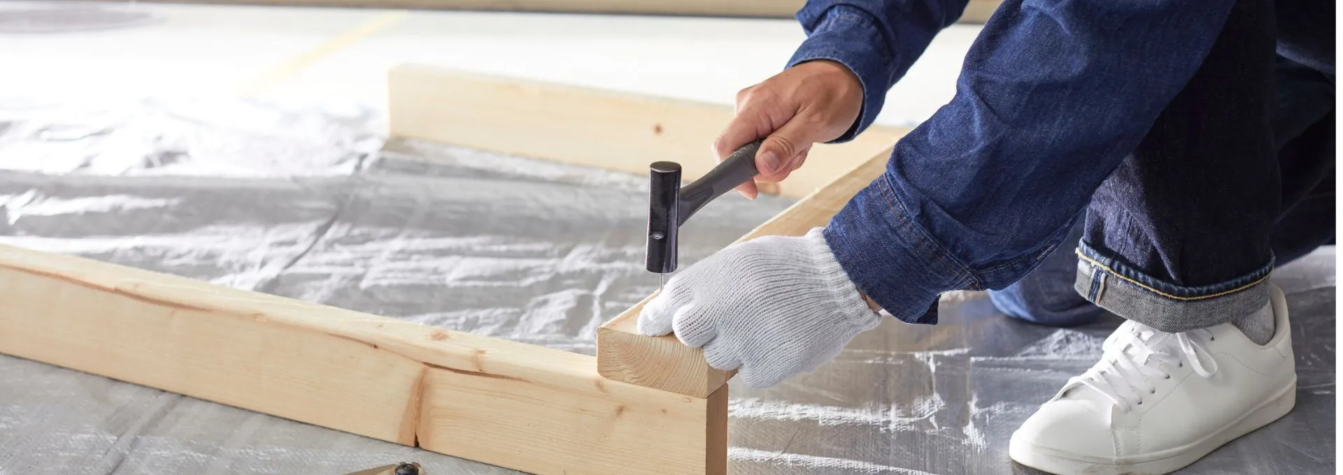 Person using a hammer and doing home construction