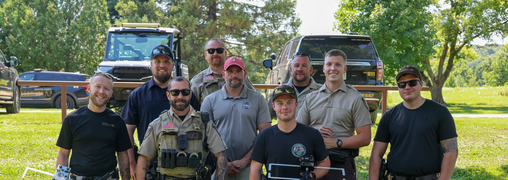 Members of the Olmsted County Sheriff's Office stand with other local law enforcement during project lifesaver training at oxbow park in Olmsted County. 