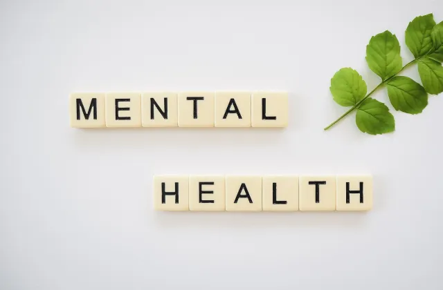 tiles that read mental health with greenery nearby