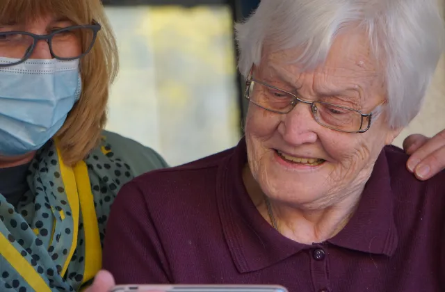a doctor and an older woman looking at a phone