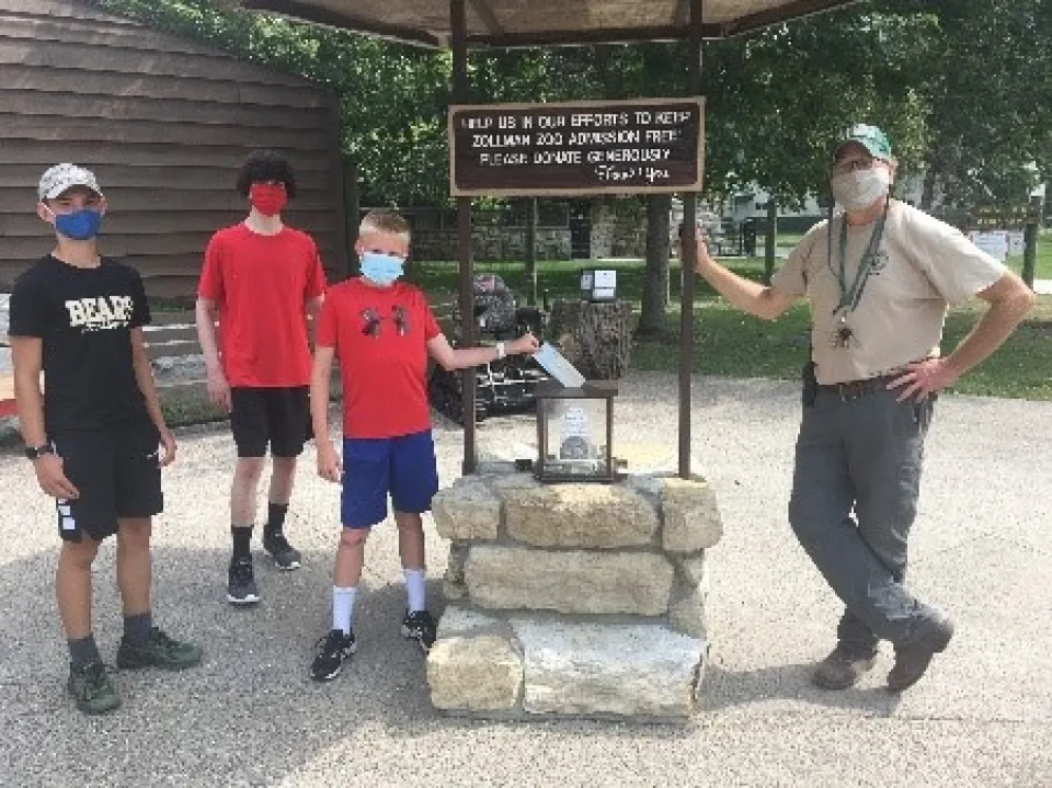 Presenting the check to Oxbow Park Manager, Lonnie, are Team R.E.D. members (left to right) Tristan, Marvin, and Jonas