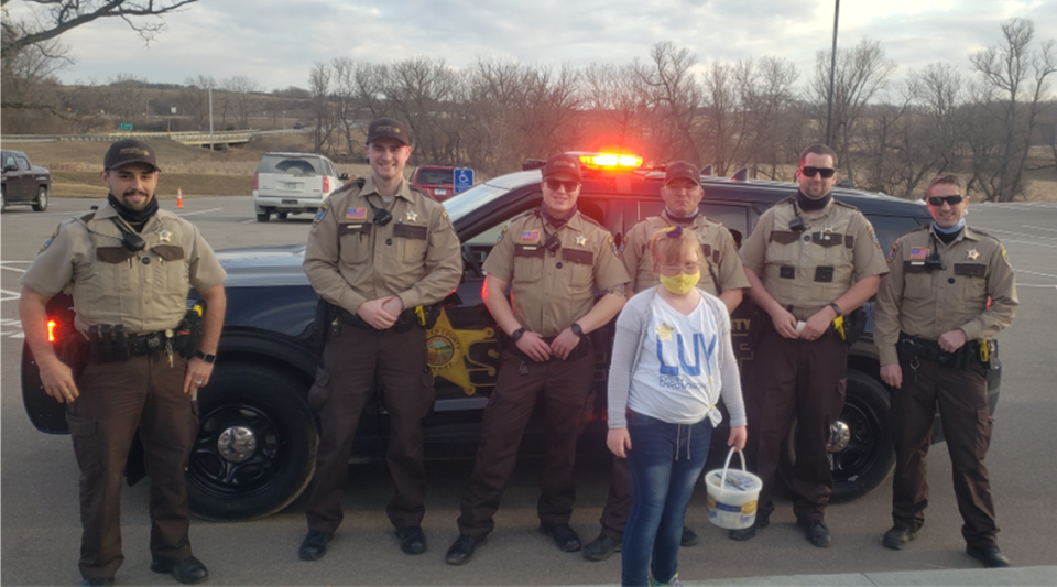 Olmsted County Deputies pose with Ava, who invited them for ice cream