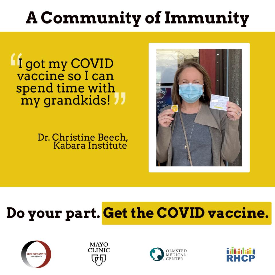 An image of Dr. Christine Beech of the Kabara Institute, a white female wearing a mask and holding her COVID-19 vaccine card and a sticker with the quote "I got my COVID vaccine so I can spend time with my grandkids."