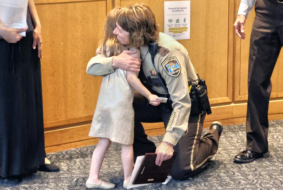 Deputy Tracey Pagel and Evelyn share a hug at the awards program.