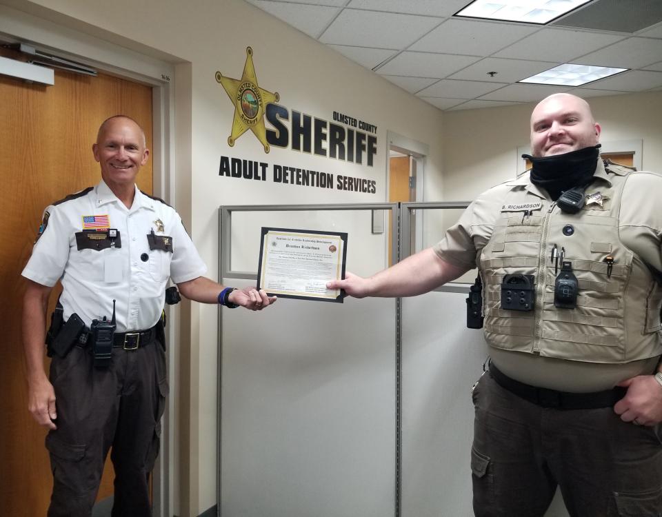 Sheriff Torgerson presents Deputy Richardson with certificate