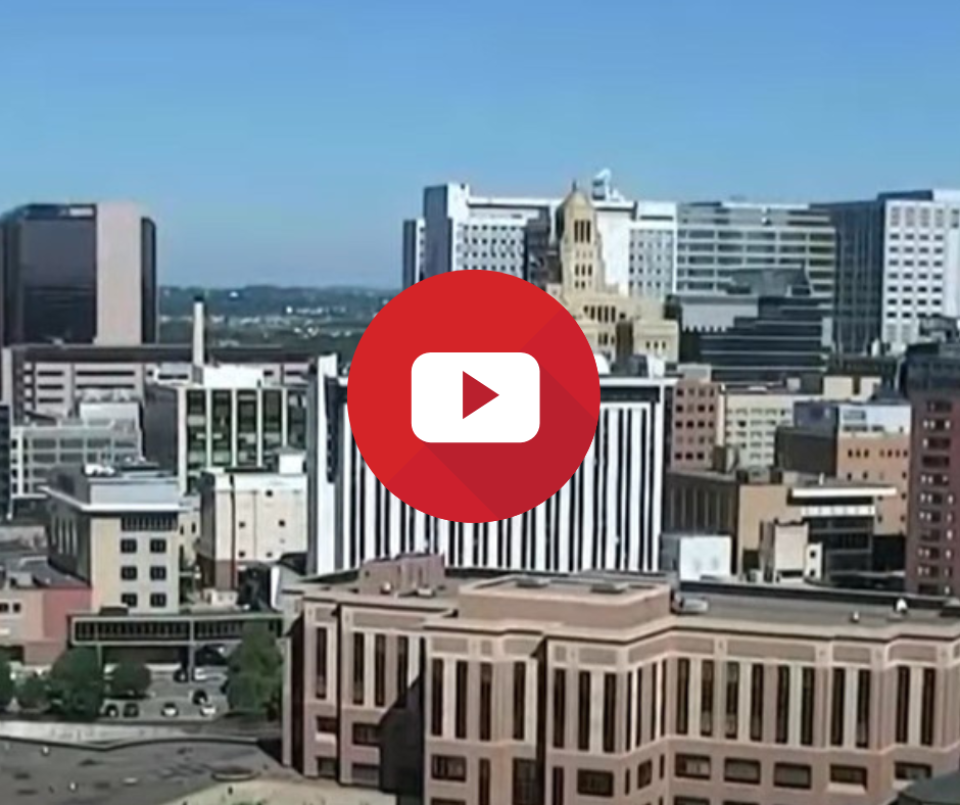 City of Rochester skyline with a play button