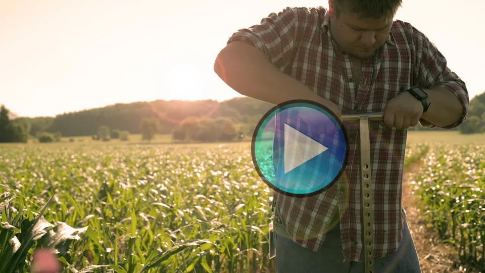 Video still of a man testing soil