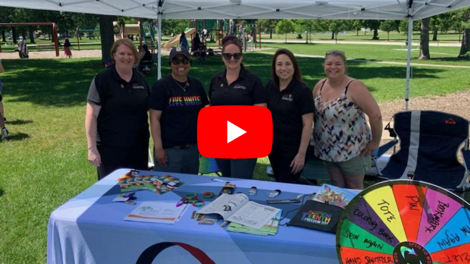 Image of Olmsted County employees at a community event with a "play" button. Click the image to view the One Olmsted video.