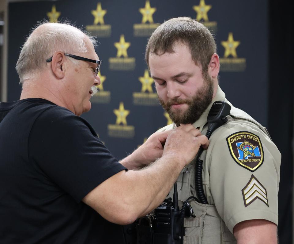 Sergeant Waletzki has badge pinned by father.