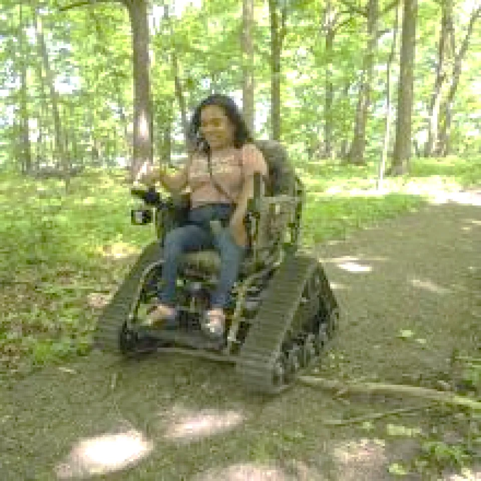 a woman riding an all-terrain wheelchair