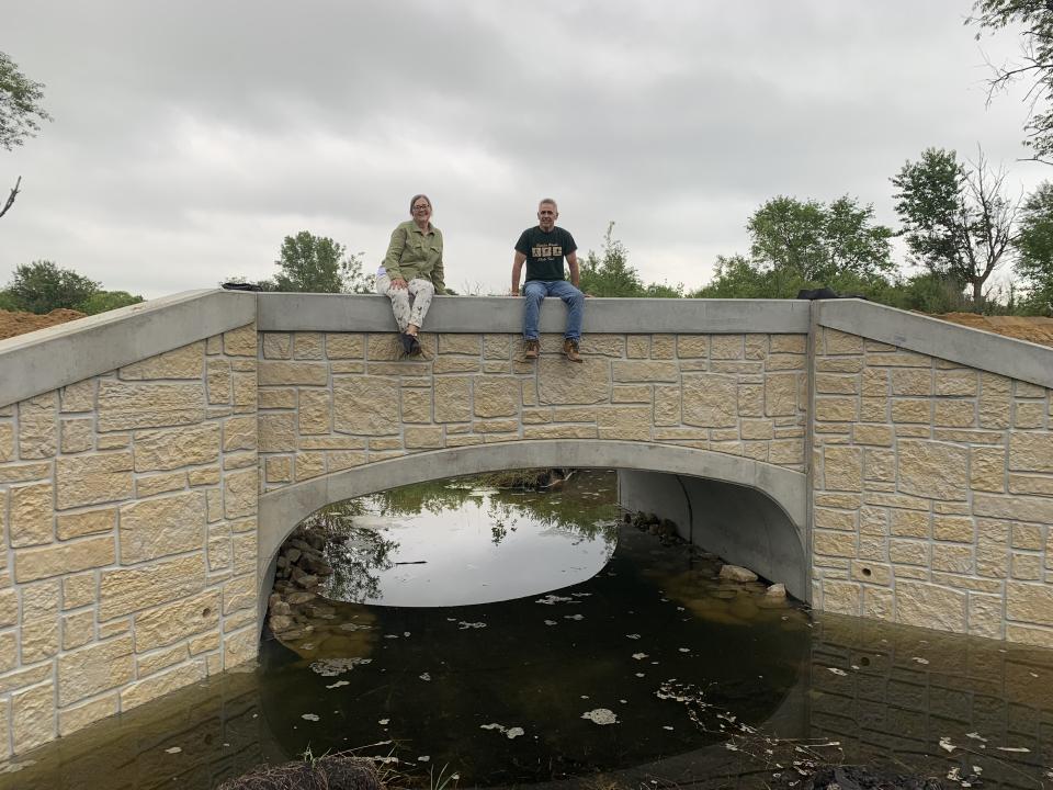 Bluffland Trail Bridge with Iris Clark and Jeff St. Mane siting on top
