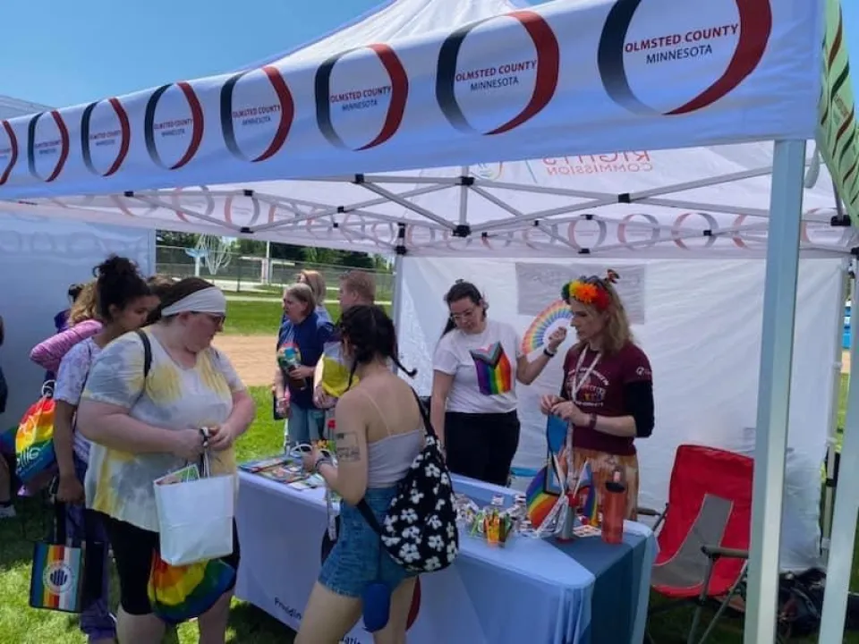 group of people standing around a tent at an event