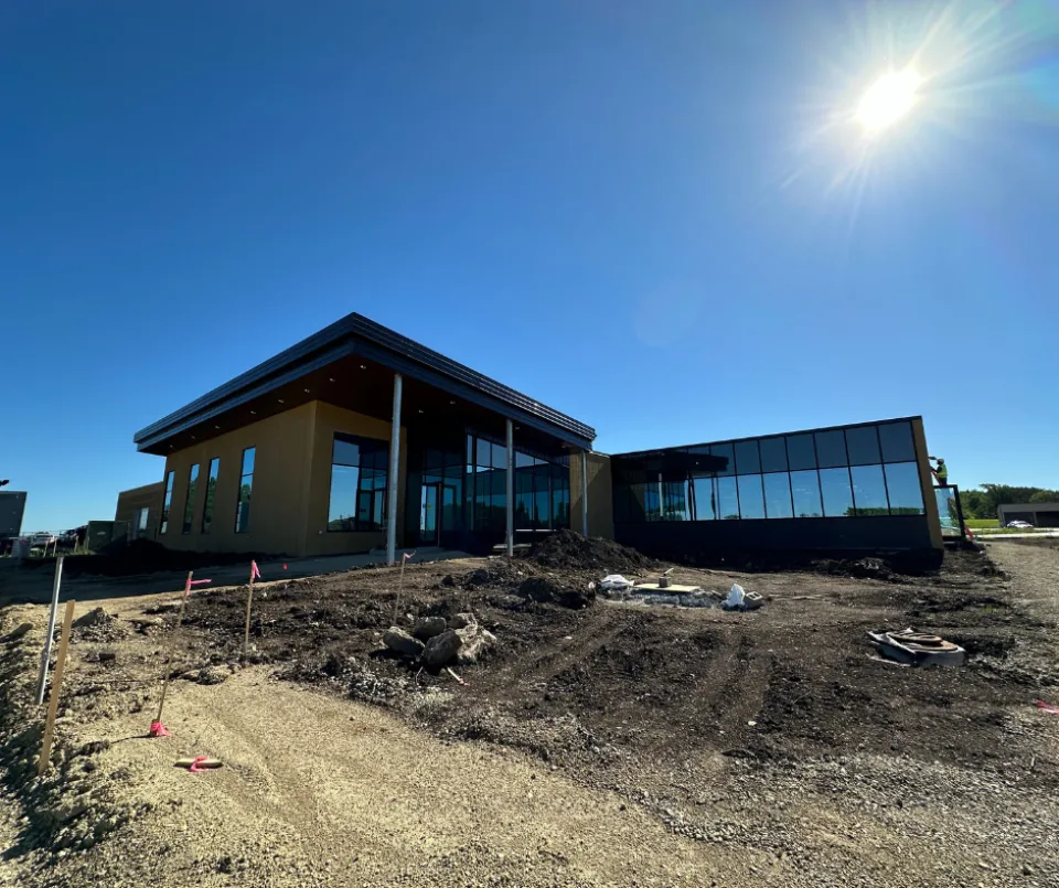 A portion of the Public Works Service building under construction with the sun shining down on it.