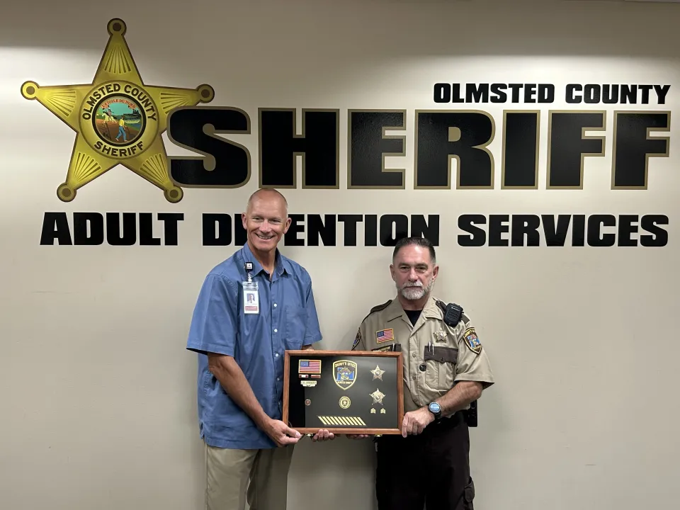 Sheriff Torgerson poses for a photo with Dave Shufelt celebrating his retirement