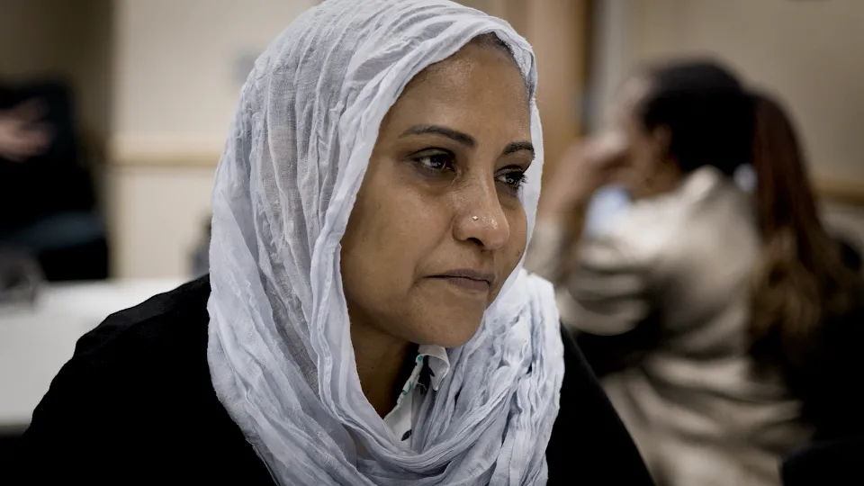 Person looking off into the distance during meeting