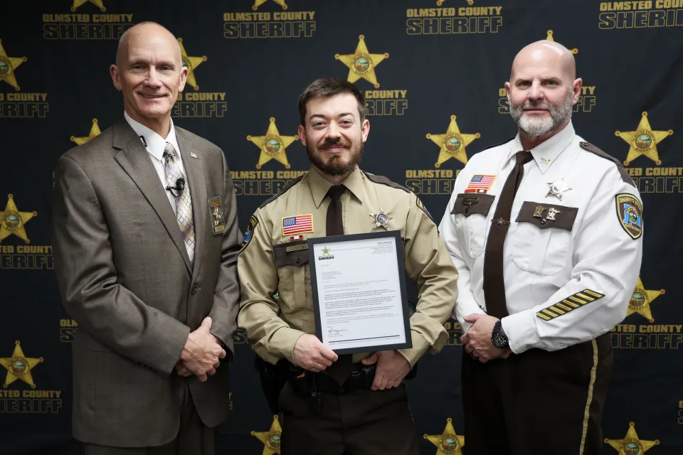 Deputy John Davis with Sheriff Torgerson and Chief Deputy James Schueller. Davis received a letter of recognition for his unwavering commitment to promoting traffic safety within Olmsted County in 2024.