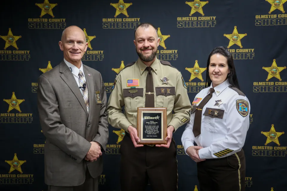 Corporal Justin Dombrovski with Sheriff Torgerson and Director Sam Reps. Corporal Dombrovski was awarded the Life Saving Award for his actions, which resulted in a life being saved inside the Adult Detention Center.