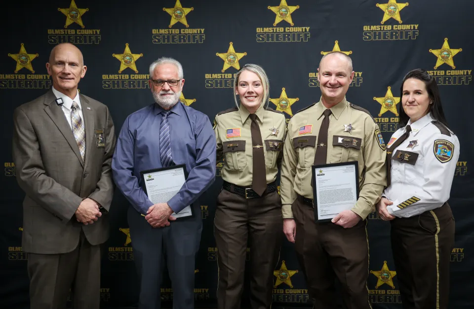 Detention Deputy Franck Nourry-Cabrol (right center) and Dr. Steven Norton (left center) received letters of recognition for handling an incident with an exceptional level of professionalism inside the Adult Detention Center. Detention Deputy Lindsay Alexander (center) nominated them.