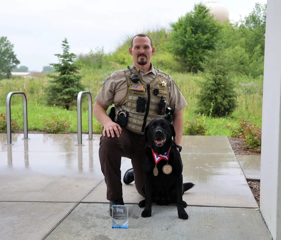 Deputy Erik Ikler and K9 Huey with awards