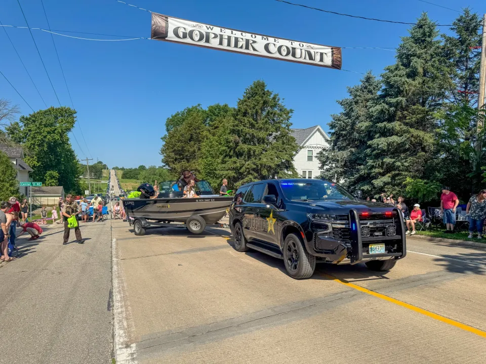 Sheriff's Office Squad pulling a boat in the 2025 Gopher Count Parade