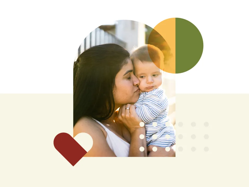 A woman snuggling a baby