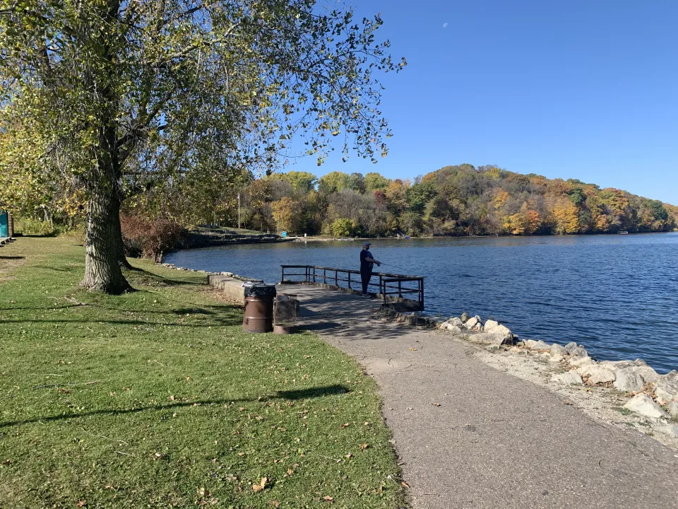 fishing pier with fall trees