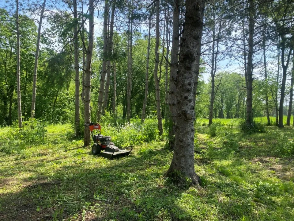 Brush Mower sitting in the grass 
