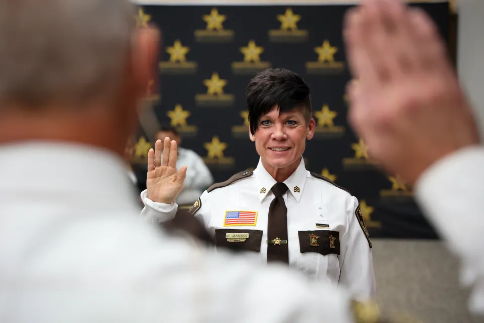 Sergeant Mollie Jennings from the Adult Detention Center is publicly sworn in by Sheriff Torgerson before receiving her Certificates of Promotion.