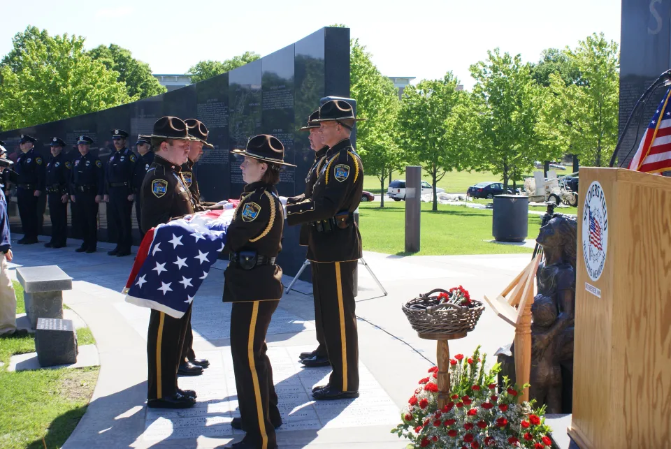 Sheriff's Office Honor Guard folding a flag at memorial program