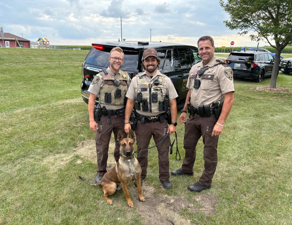 Members of the Sheriff's Office pose with a K9 at Night to Unite in 2025