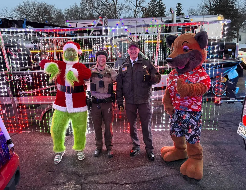 Members of the sheriff's office pose for a photo before the Holiday Lights parade in Rochester in 2025