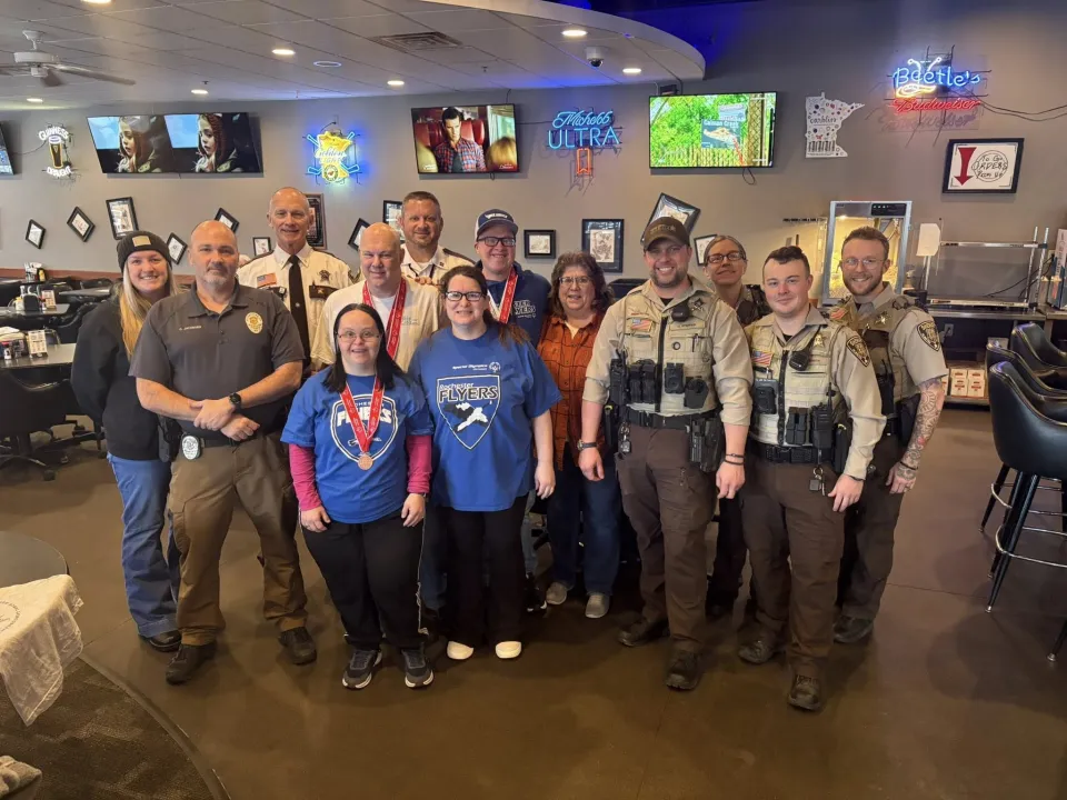 Members of the Sheriff's Office and Rochester Police department pose for a photo with special Olympics athletes inside Beetle's Bar and Grill