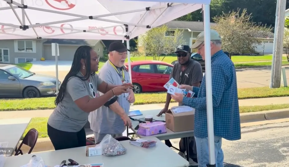 People sharing information and interacting at event