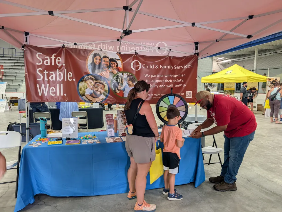 CFS staff interacting with a family at event