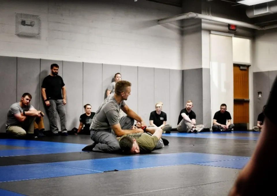 Class doing hands on training on a mat