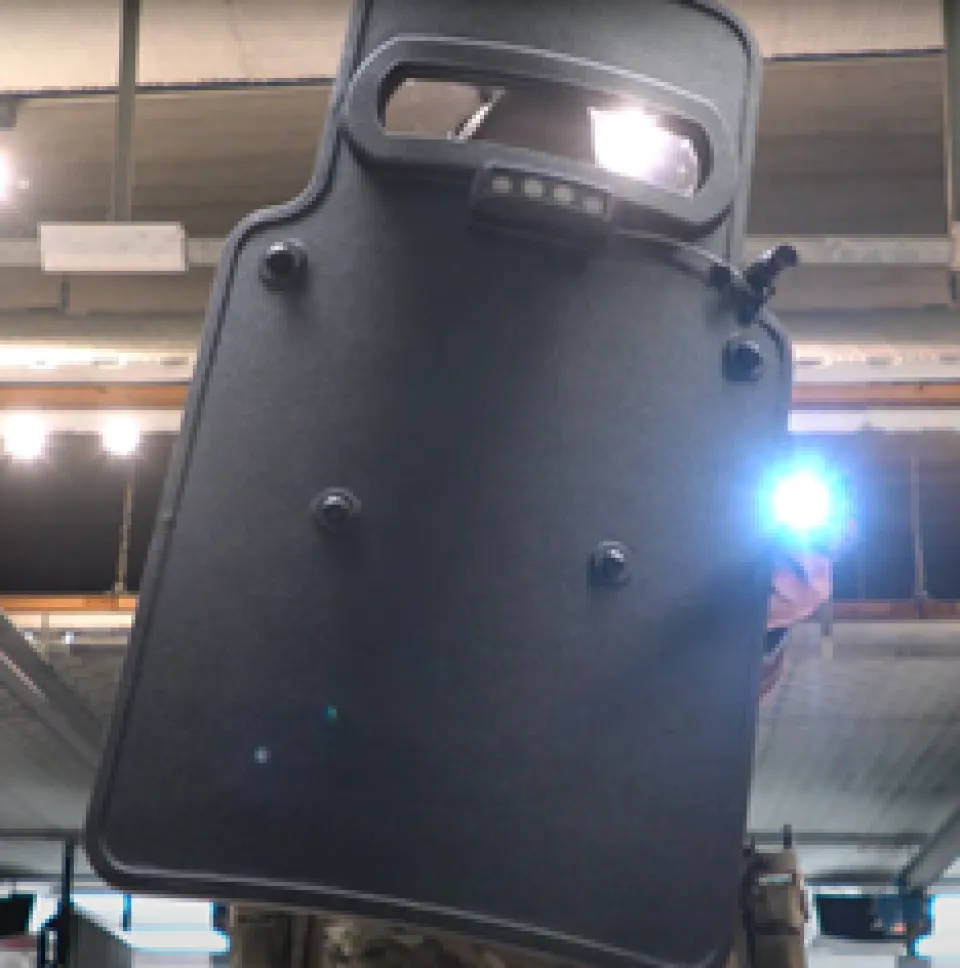 Shield being help by a law enforcement officer during training