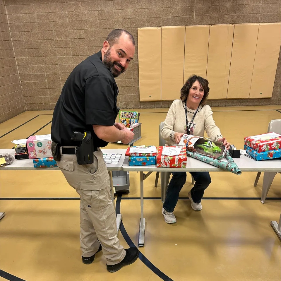 People wrapping presents for detainees inside the Adult Detention Center
