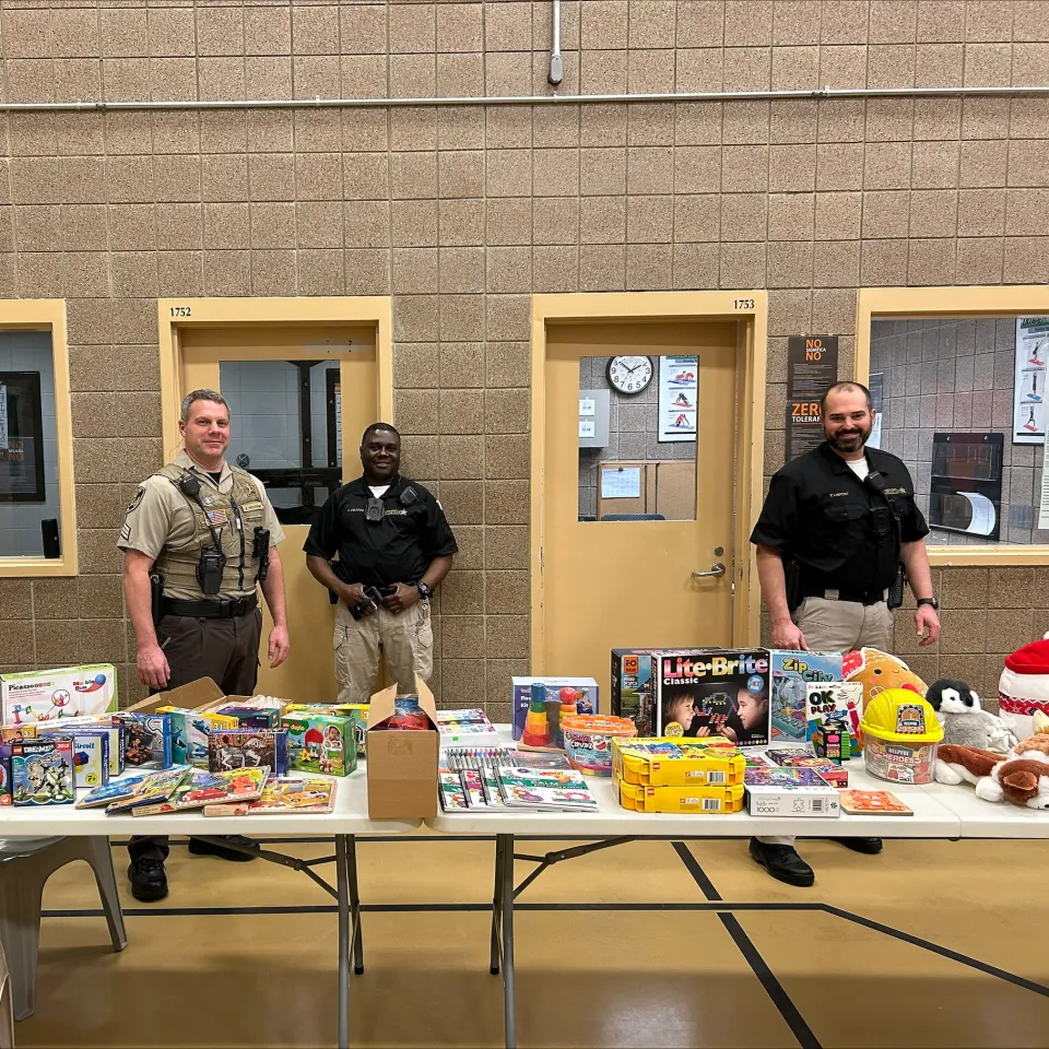 People wrapping presents for detainees inside the Adult Detention Center