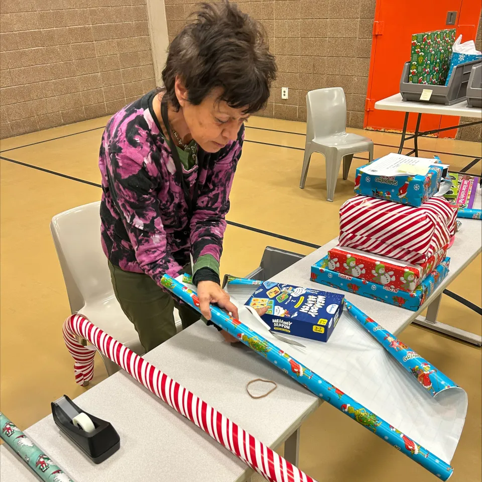 People wrapping presents for detainees inside the Adult Detention Center