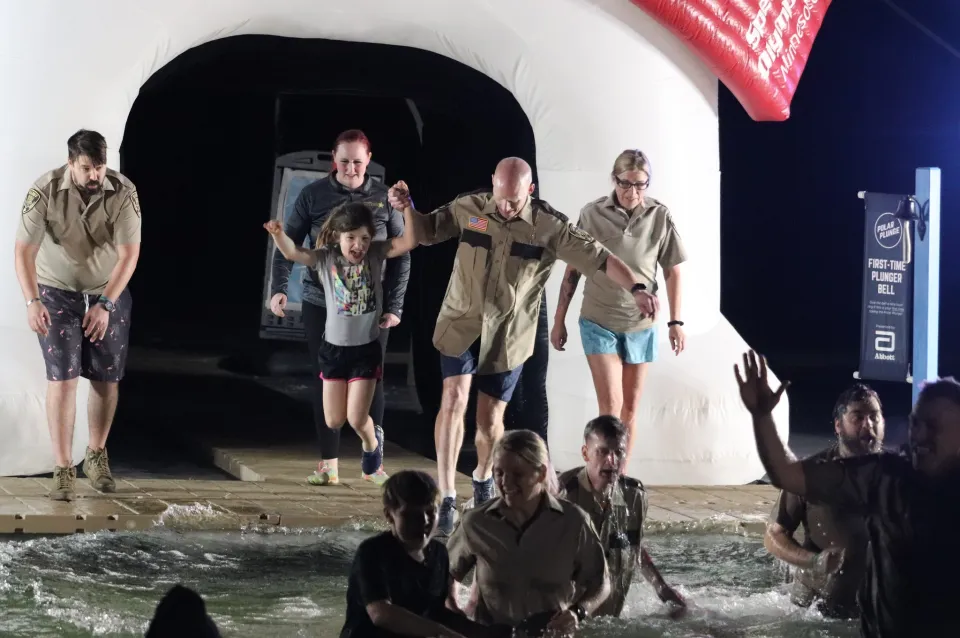Members of the Sheriff's Office take the polar plunge. 