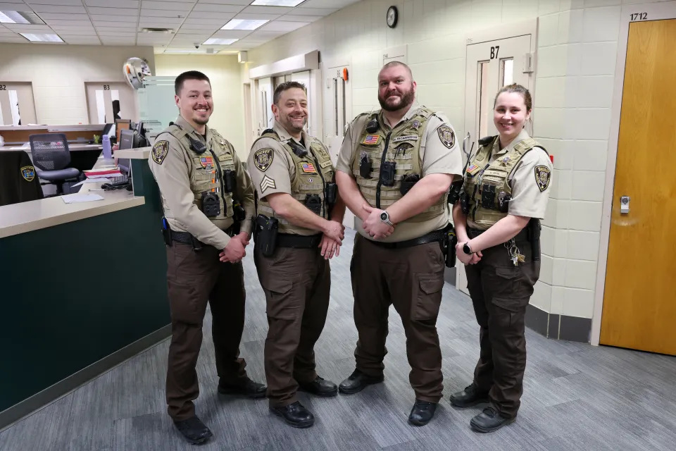 Members of the booking team standing in the detention center