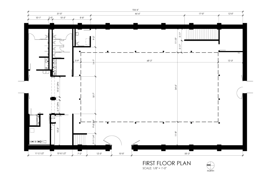 Floor plan for Floral Hall showing a central north entrance leading to a corridor with restrooms on the east side and utility rooms on the west. The south end opens into a large gathering hall with a surrounding balcony, two staircases, and multiple exterior doors. 
