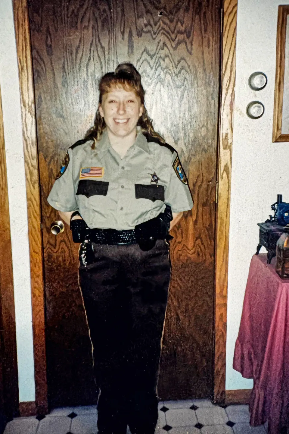 Captain Macey Tesmer stands in front of a door before her first night of working.