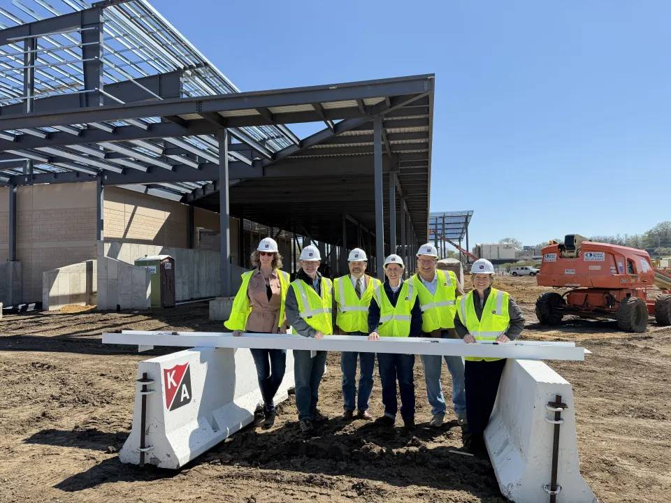 Some Olmsted County board of commissioners signing beam