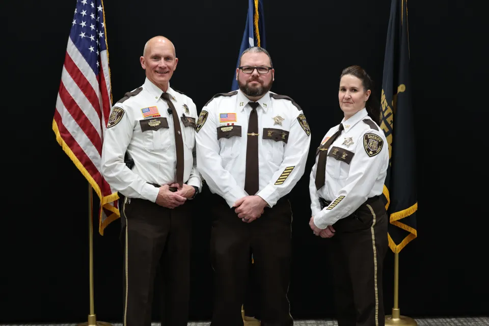 Newly promoted detention captain Luke Wrubel stands with Sheriff Torgerson and Director Sam Reps