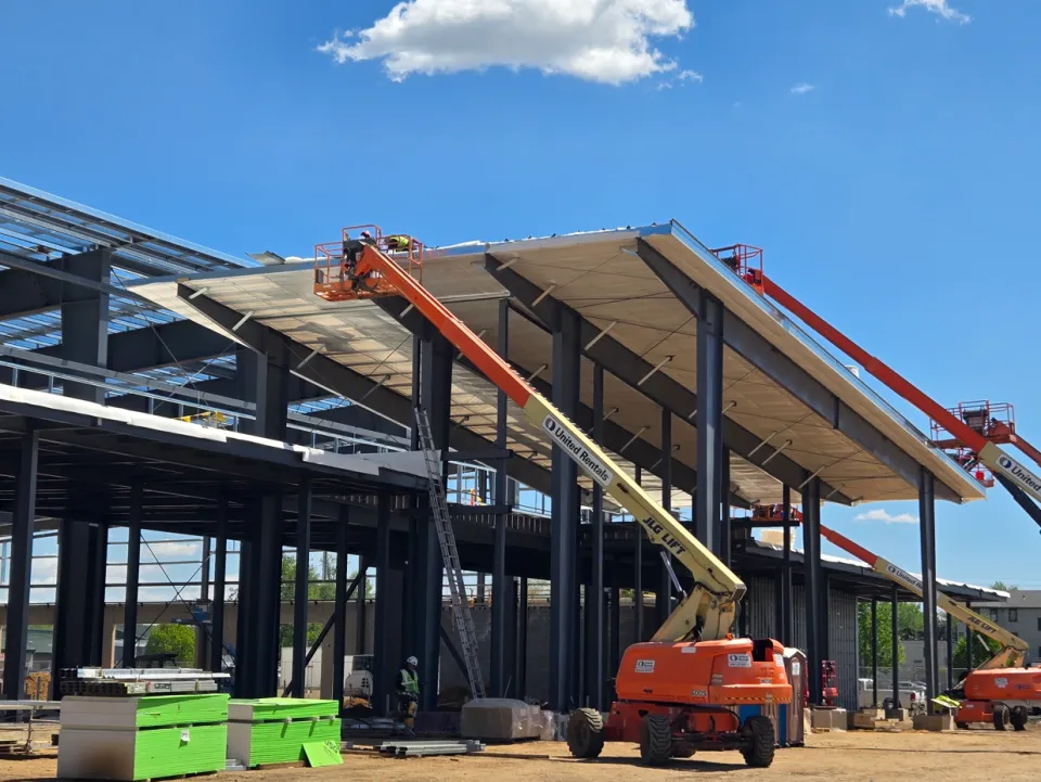 Crane putting solar on roof of exhibition center 