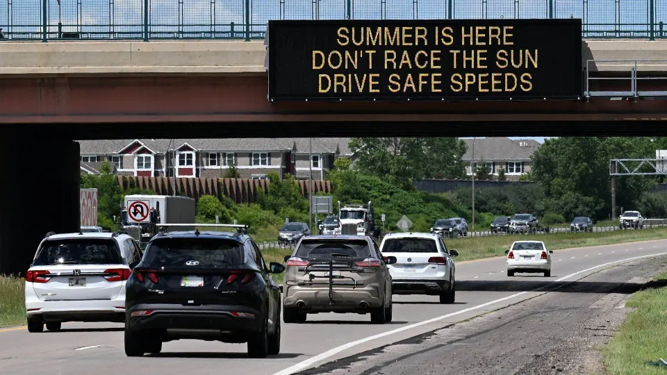 Traffic Sign on Minnesota road that reads: Summer is head. Don't race the sun. Drive safe speeds.